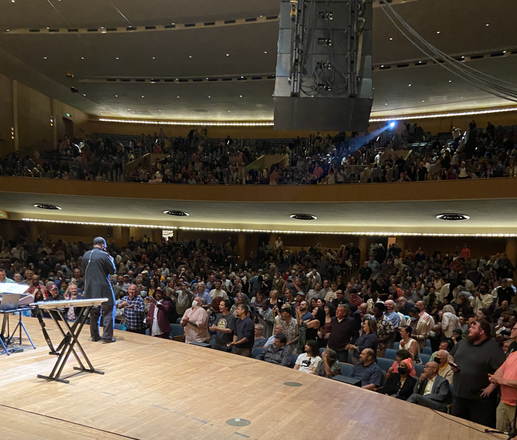 Herbie Hancock performing before a large audience in the Kleinhans Main Hall